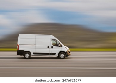 Cargo van is driving on the highway at speed with a blurred background. Freight transport, commercial transport concept with free space for text, copy space.