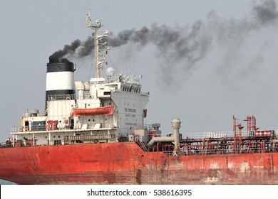 Cargo Vessel Belching Smoke While Traveling Up Malacca Strait In Malaysia