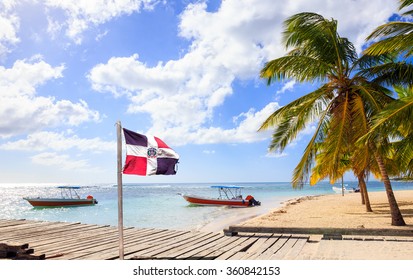 Caribbean beach and Dominican Republic flag on Saona island