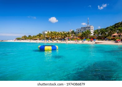 Caribbean beach, palm trees in resorts and turquoise sea in Montego Bay, Jamaica island.