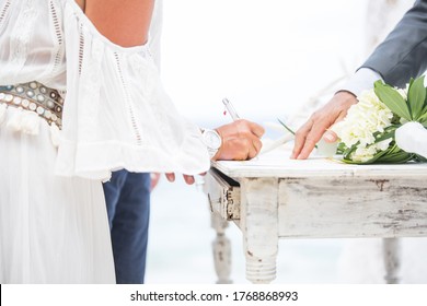Caribbean beach white wedding ceremony in Curaçao. Signing the wedding certificate - Shutterstock ID 1768868993
