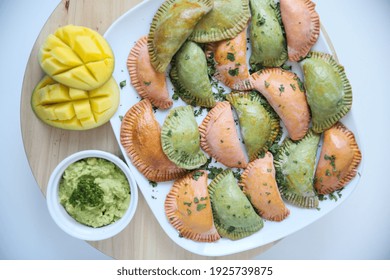 Caribbean Beef Empanadas With Mango On A White Plate