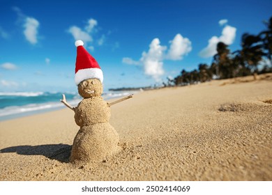 Caribbean Christmas Snowman with Santa Claus Hat made out of sand on sandy beach. Holiday vacation in hot countries concept. New Year travel greeting card - Powered by Shutterstock