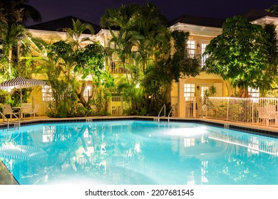 The Caribbean Court Boutique Hotel
September 29, 2021, USA

Night Scene With Lighting Of The Building, Tropical Park, Swimming Pool With Loungers, Umbrellas And Chairs