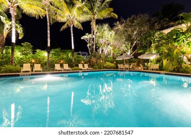 The Caribbean Court Boutique Hotel
September 29, 2021, USA

Night Scene With Lighting Of The Building, Tropical Park, Swimming Pool With Loungers, Umbrellas And Chairs