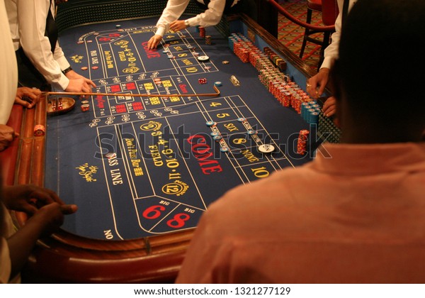 Caribbean Islands July,12,2009: \
Gamers  enjoying a game of chance at the casino craps\
table.
