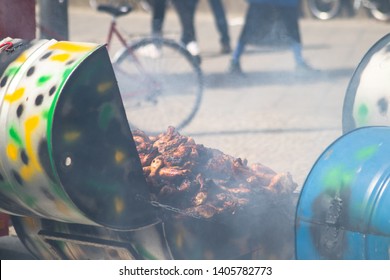 Caribbean jerk chicken being barbecued and sold as street food.