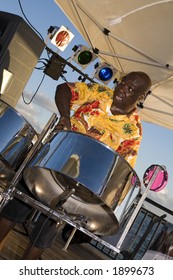 A Caribbean Musician Jamming On His Steel Drums.