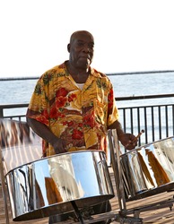 A Caribbean Musician Playing Steel Drums.