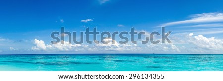 Caribbean panorama Hawaiian Maldivian Bahamian coast with a boat in a turquoise tropical sea. Siladen turquoise tropical paradise island in Indonesia landscape panorama. Panorama of sea waves.