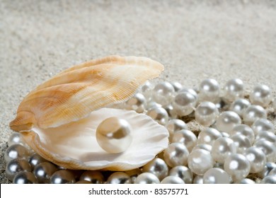 Caribbean Pearl Inside Clam Shell Over White Sand Beach