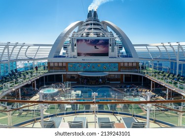 Caribbean Sea - 2022: Emerald Princess Cruise ship. Upper decks of the ship. Calypso Reef and Pool, Movies under the stars, smoke stacks. 