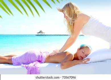 Caribbean turquoise beach chiropractic massage therapy woman [Photo Illustration]