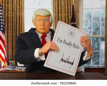 Caricature Of United States President Donald Trump Holding Up An Executive Order That States: I'm Really Rich - Which Trump Has Been Quoted Saying On Numerous Occasions During His Campaign 