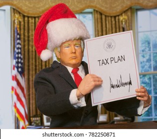 Caricature Of United States President Donald Trump Holding Up An Executive Order That States: Tax Plan, Which Was Signed As A Partisan Republican Law