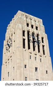 carillon bell tower with clock against blue sky - close-up