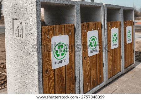 Caring about an enviroment, separating garbage into different continers. Garbage bins for separate waste sorting in park. Separate garbage collection containers on a park. Collection of plastic, paper, glass and mixed wasted for further processing