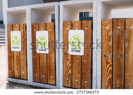 Caring about an enviroment, separating garbage into different continers. Garbage bins for separate waste sorting in park. Separate garbage collection containers on a park. Collection of plastic, paper, glass and mixed wasted for further processing
