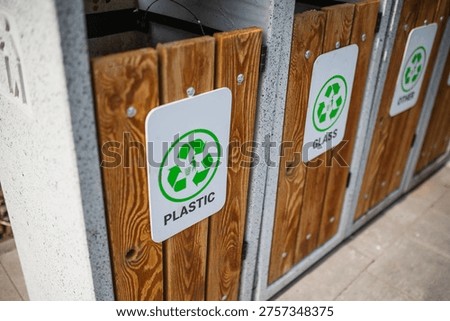 Caring about an enviroment, separating garbage into different continers. Garbage bins for separate waste sorting in park. Separate garbage collection containers on a park. Collection of plastic, paper, glass and mixed wasted for further processing