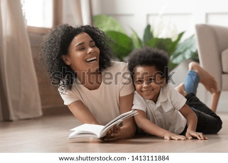 Similar – Image, Stock Photo Mother and son having fun while studying documents on yellow file