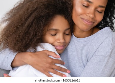 Caring African American Single Mother Hugging Teenage Daughter, Happy Black Mom Embracing Teen Girl Cuddling Enjoy Moment Of Love, Mum And Child Warm Relationship, Motherhood Concept, Close Up View