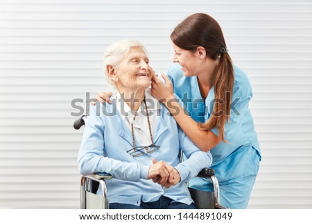 Similar – Doctor talking to elderly patient in a wheelchair