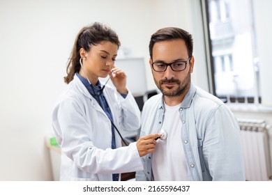 Caring Caucasian Female Doctor Use Phonendoscope Examine Male Patient Heart Rate At Consultation In Hospital. Woman Nurse Or GP Use Stethoscope Listen To Man Heartbeat In Clinic.