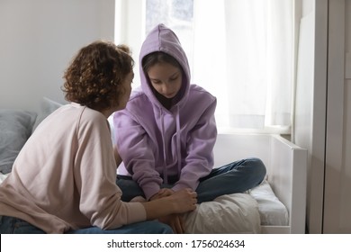 Caring Caucasian mother talk comfort unhappy sad teenage daughter suffering from school bullying or psychological problems, loving mom support make peace with depressed introvert teen girl child - Shutterstock ID 1756024634