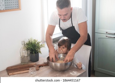 Caring Dad And Cute Little Preschooler Daughter Cooking In The Kitchen Together - Happy Father And Little Girl Child Making Pizza Or Bread Dough At Home - Cooking Together Concept - Family In Kitchen