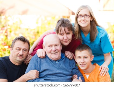 Caring Doctor Together With Her Patient's Family.