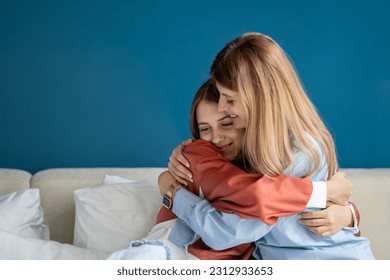 Caring European mother hugging teenage girl. Pleased mom and teen daughter feel grateful thankful, show love and care, enjoy tender. Family embracing, having intimate moment together as best friends.  - Shutterstock ID 2312933653