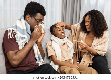 Caring Family Checking Temperature Sick Child. Mother Comforts, Father Blows Nose, Illness, Health Care, Home - Powered by Shutterstock