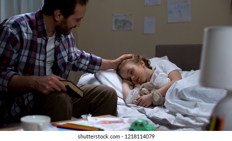 Caring father reading story book and daughter falling asleep, tender attitude - Powered by Shutterstock