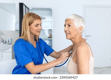 Caring female doctor use phonendoscope examine senior patient heart rate at consultation in hospital. Woman nurse or GP use stethoscope listen to woman's heartbeat in clinic. - Powered by Shutterstock