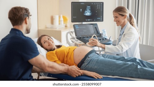 Caring Female Hospital Obstetrician Conducting an Ultrasound Exam for a Pregnant Woman. Young Couple Watching the Screen while Doctor Describes the Baby’s Growth to Expectant Mother - Powered by Shutterstock