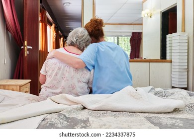 Caring geriatric nurse hugging and comforting sick senior woman in hospice or nursing home - Powered by Shutterstock