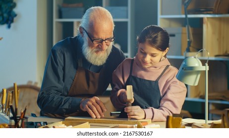 Caring Grandfather with his Teenage Granddaughter Spend Time Together, Work on Wood, Enjoying Communication in the Workshop. Hobby Garage. Communication Between Generations, Family and Mental Health. - Powered by Shutterstock