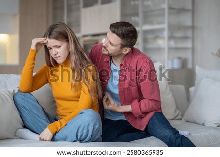 Caring guy trying to explain justify to emotional girl. Offended wife ignoring husband making excuses. Spouses squabbling, arguing, fighting. Quarrel over distrust, jealousy, insecurity of woman.