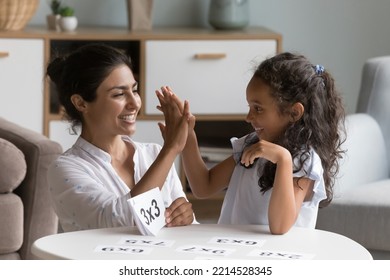 Caring Indian mother checks daughter skills in multiplication, family learning together use flash cards, mom praises child give high five gesture. Mathematics basic, preparation for school, education - Powered by Shutterstock