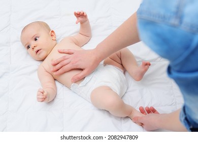 A Caring Mother Gives Her Baby Son A Tummy Massage And Helps To Get Rid Of Colic.