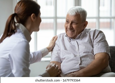 Caring nurse talks to old patient holds his hand sit in living room at homecare visit provide psychological support listen complains showing empathy encouraging. Geriatrics medicine caregiving concept - Powered by Shutterstock