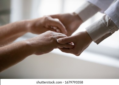 Caring Nurse In White Coat Holding Hands Of Old Man Patient Express Compassion Provide Physical Or Psychological Help, Arms Close Up. Concept Of Relief Loneliness, Incurable Disease, Nursing, Empathy