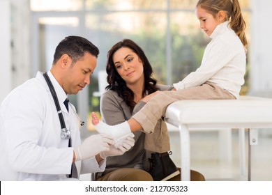 caring paediatrician bandage little patient's ankle  - Powered by Shutterstock