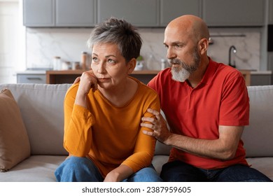 Caring Senior Husband Comforting His Upset Offended Wife At Home, Worried Man Apologizing After Quarrel, Supporting Sad Souse, Mature Couple Suffering Relationship Crisis, Closeup Shot - Powered by Shutterstock