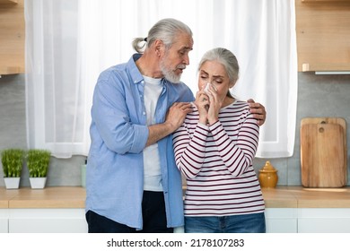 Caring Senior Man Comforting His Crying Wife While They Standing In Kitchen At Home, Sad Elderly Lady Suffering Depression Or Mental Breakdown, Sobbing And Wiping Nose With Napkin, Copy Space