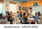 Caring Teacher Explaining a Math Lesson to a Classroom Full of Bright Diverse Children. Little Girl Raising Her Hand and Asking Tutor a Question. Primary School with a Group of Smart Multiethnic Kids
