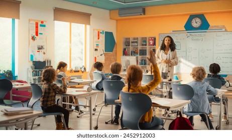 Caring Teacher Explaining a Math Lesson to a Classroom Full of Bright Diverse Children. Little Girl Raising Her Hand and Asking Tutor a Question. Primary School with a Group of Smart Multiethnic Kids - Powered by Shutterstock