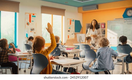 Caring Teacher Explaining a Math Lesson to a Classroom Full of Bright Diverse Children. Little Girl Raising Her Hand and Asking Tutor a Question. Primary School with a Group of Smart Multiethnic Kids - Powered by Shutterstock