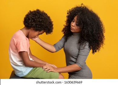 Caring Worried African American Mother Holding Hand Of Sad Little Mixed Race Son Talking Giving Support And Comfort, Black Mom Foster Parent Consoling Kid.