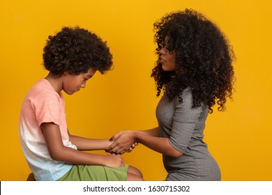 Caring Worried African American Mother Holding Hand Of Sad Little Mixed Race Son Talking Giving Support And Comfort, Black Mom Foster Parent Consoling Kid.